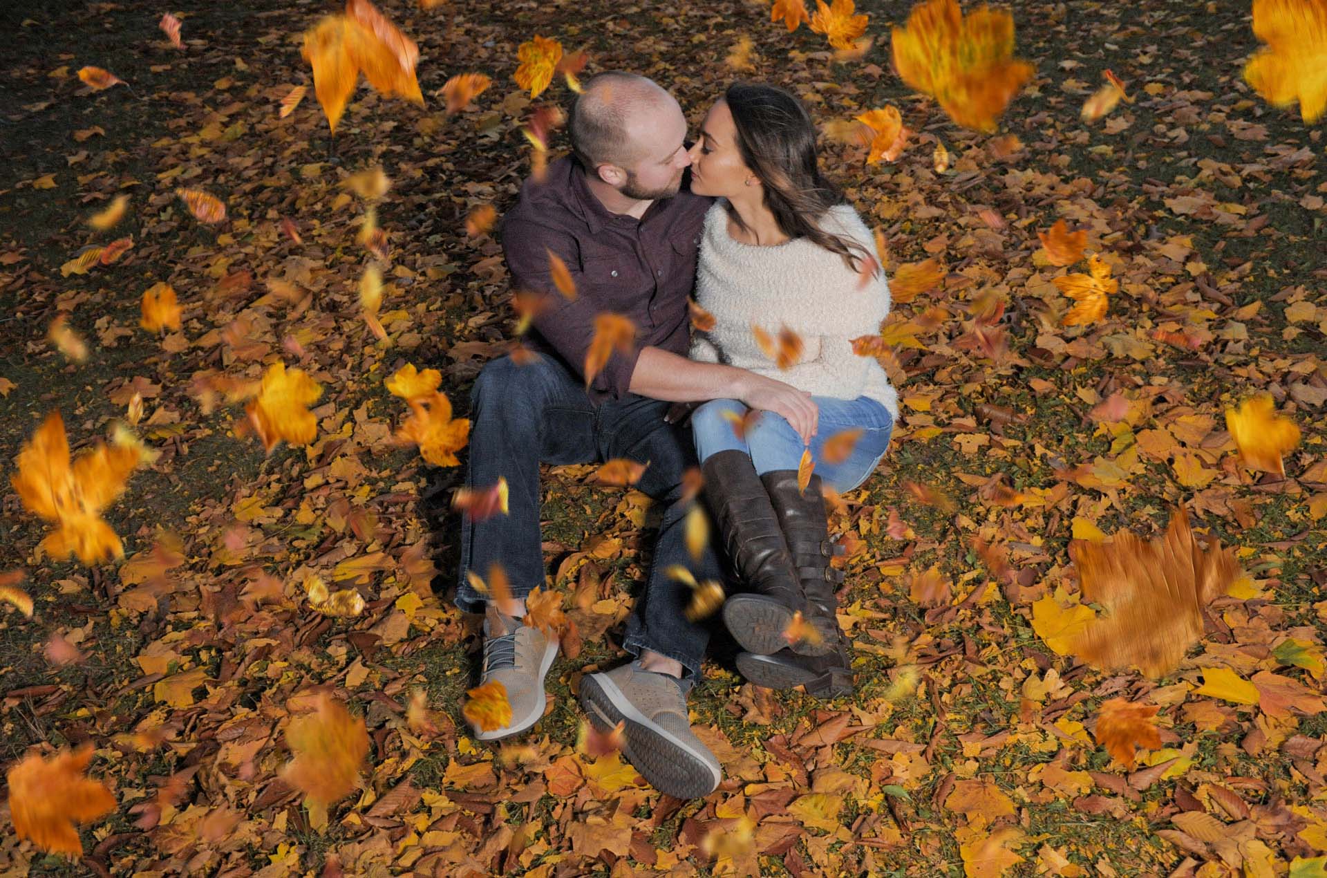 Best Rochester lifestyles photographer portraits of a soon to be married couple in Rochester, Michigan when it's raining leaves.