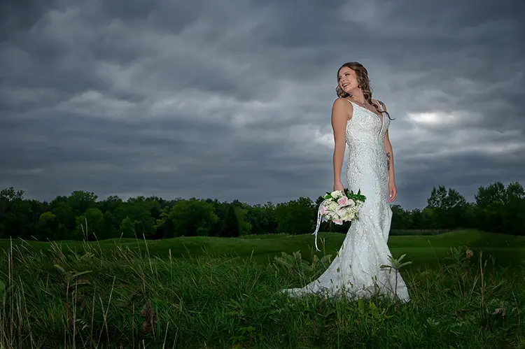 A bride looks back at the wedding party just before a storm hit at the Twin Lakes Golf Club in Michigan.