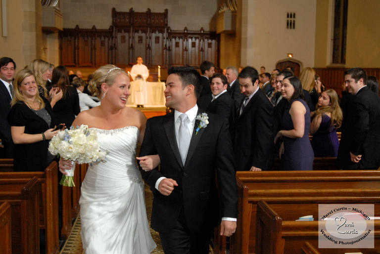 Bride and groom head down the aisle in Ann Arbor, Michigan.