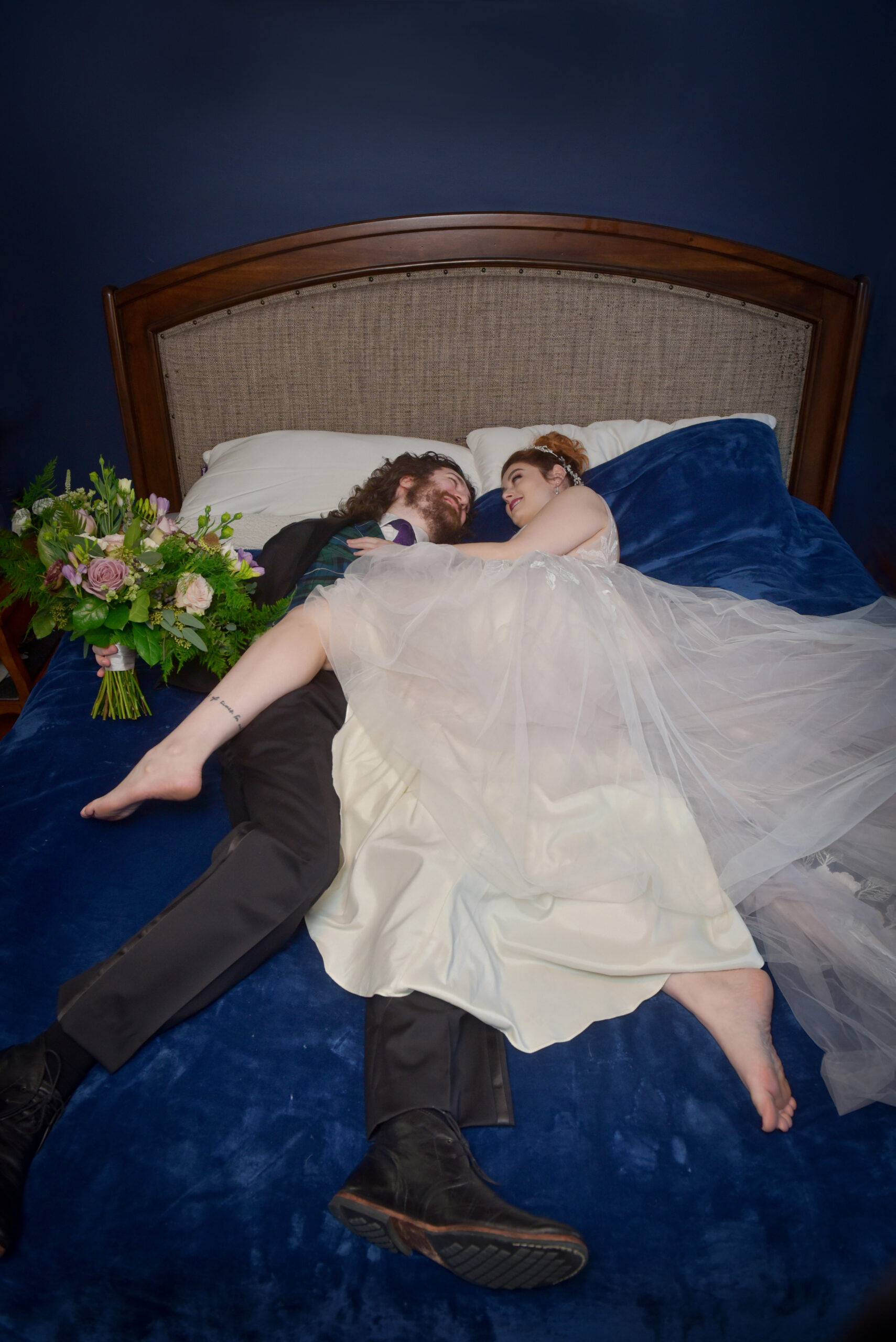 The bride and groom in their favorite location; bed!