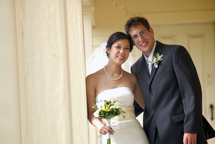 Wedding couple pose for photos after their wedding in Ann Arbor Michigan at the Cobblestone Farms